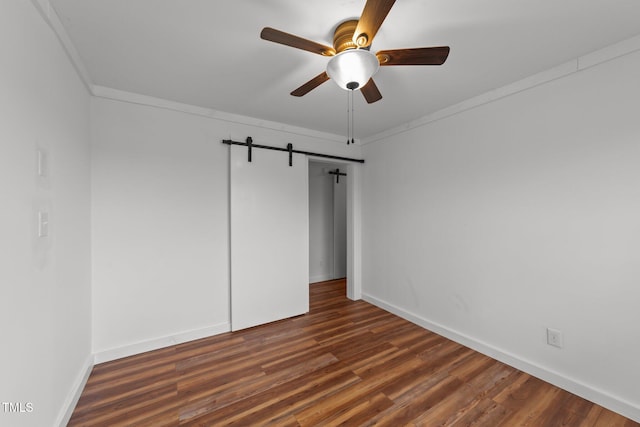 unfurnished room with ornamental molding, dark wood-type flooring, and ceiling fan