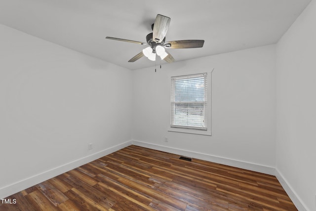 unfurnished room with dark hardwood / wood-style flooring and ceiling fan