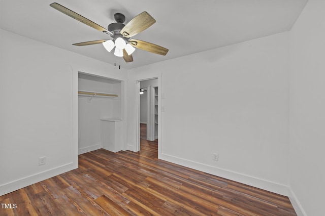 unfurnished bedroom featuring dark hardwood / wood-style flooring, a closet, and ceiling fan