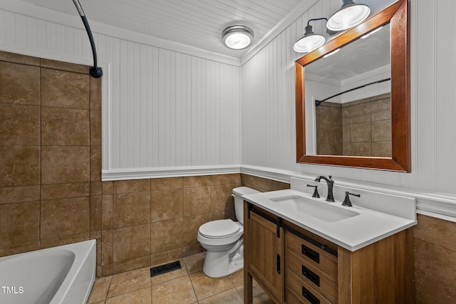 full bathroom with tile walls, vanity,  shower combination, toilet, and tile patterned floors