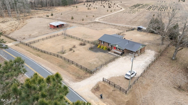 birds eye view of property with a rural view