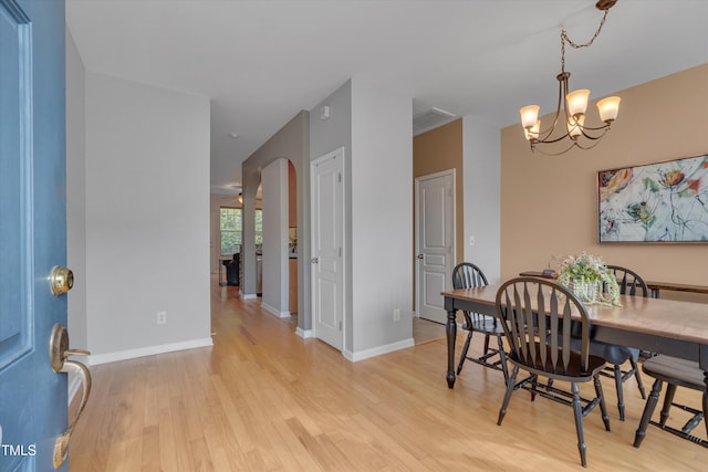 dining room featuring an inviting chandelier and light hardwood / wood-style floors