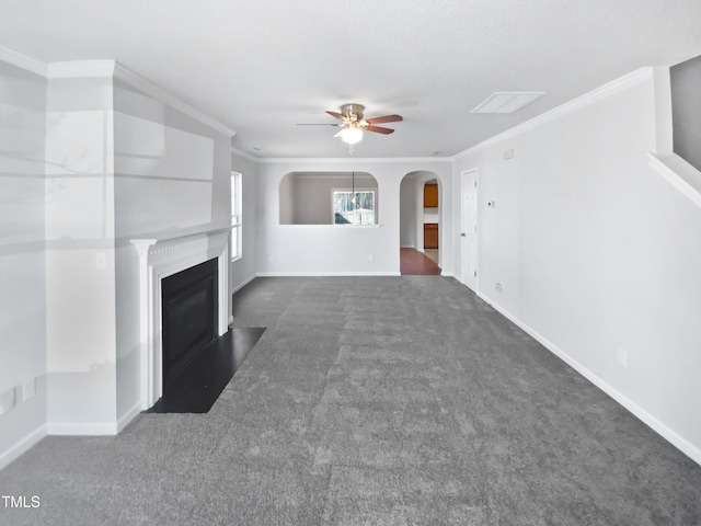 unfurnished living room featuring crown molding, ceiling fan, and dark carpet