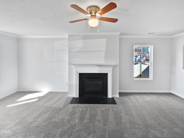 unfurnished living room featuring ceiling fan, ornamental molding, carpet floors, and a textured ceiling