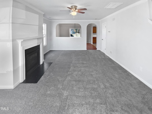 unfurnished living room featuring dark colored carpet, ceiling fan, and crown molding