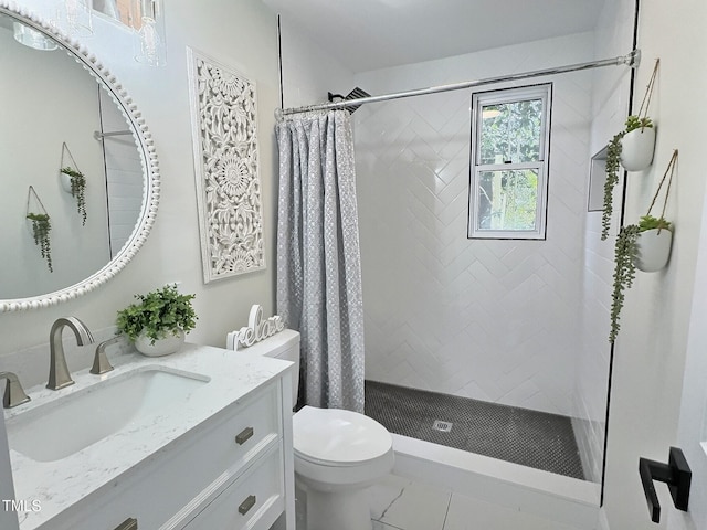 bathroom featuring walk in shower, vanity, and toilet