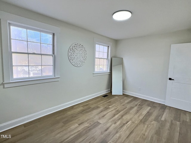 empty room with hardwood / wood-style flooring