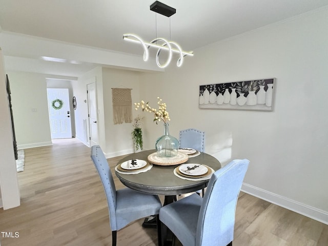 dining space featuring a chandelier and light hardwood / wood-style flooring