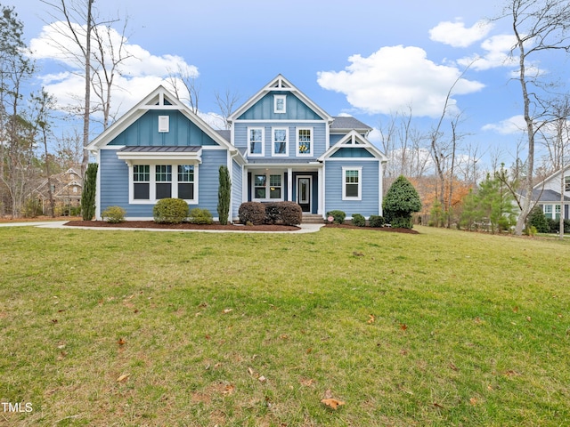 craftsman-style home with a standing seam roof, a front lawn, board and batten siding, and metal roof