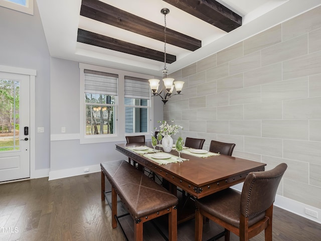 dining space with dark wood-type flooring, baseboards, an accent wall, beam ceiling, and a notable chandelier