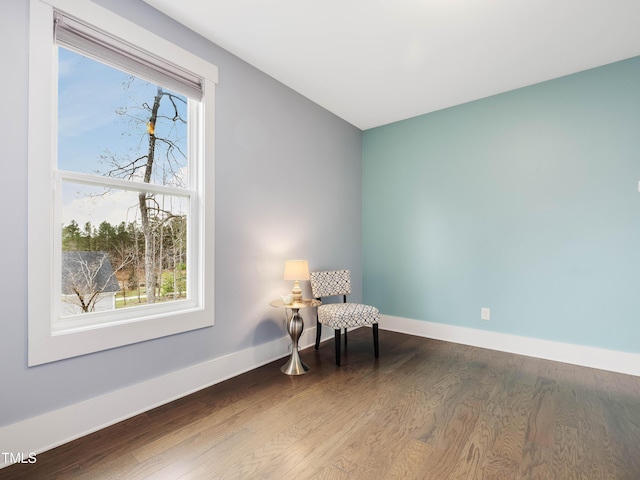 living area featuring wood finished floors and baseboards