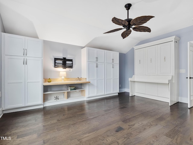 unfurnished living room featuring vaulted ceiling, dark wood-style floors, baseboards, and ceiling fan