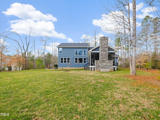 rear view of property with a lawn and a chimney