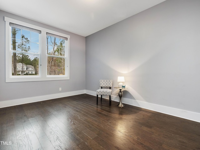 living area with baseboards and hardwood / wood-style floors