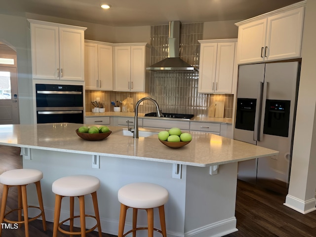 1315 Richfield Oaks Dr, Home, Fuquay Varina, NC 27526 - kitchen featuring a center island with sink, wall chimney range hood, white cabinets, and stainless steel appliances