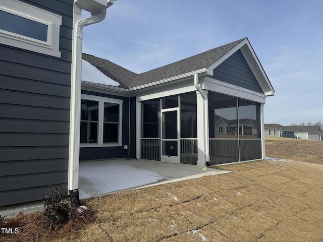 back of house featuring a patio area and a sunroom