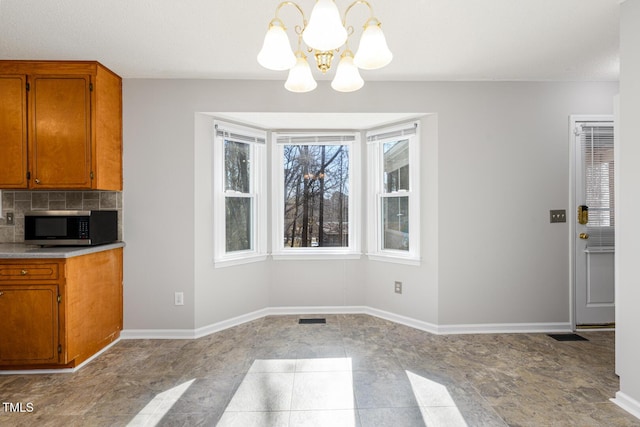 unfurnished dining area with an inviting chandelier