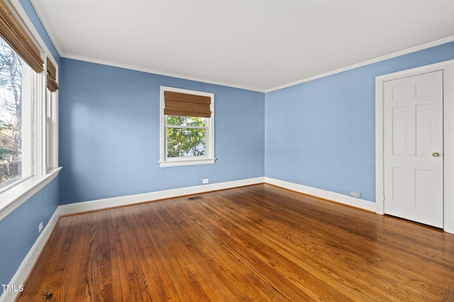 spare room featuring hardwood / wood-style floors and ornamental molding