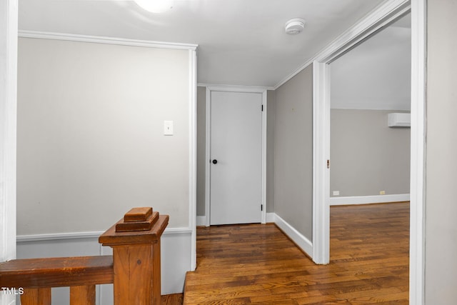 corridor featuring dark wood-type flooring and ornamental molding