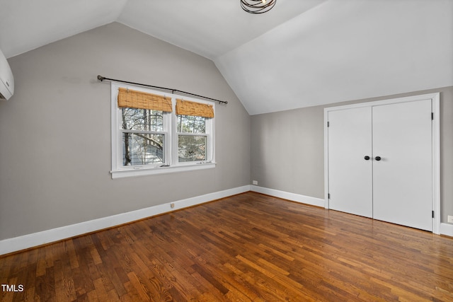 additional living space featuring wood-type flooring and lofted ceiling