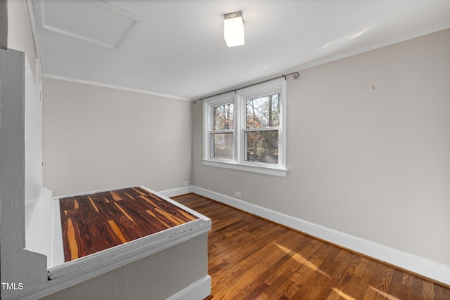 empty room with ornamental molding and dark hardwood / wood-style floors