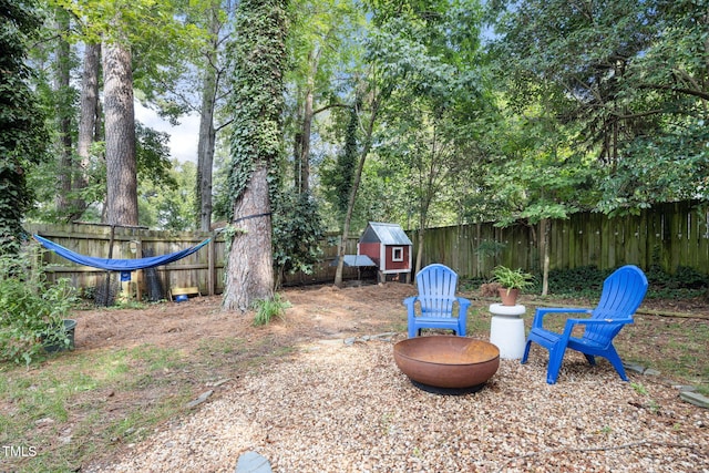 view of yard with an outdoor structure and a fire pit