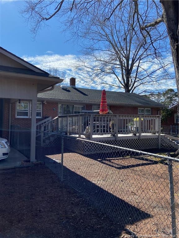 back of property with a wooden deck