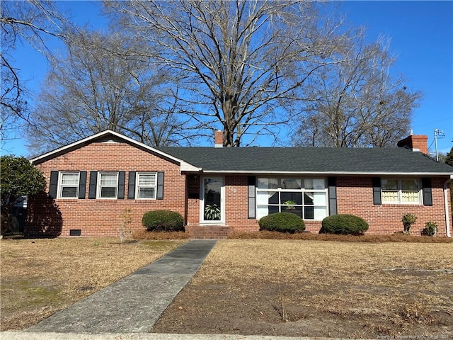 single story home featuring a shingled roof, brick siding, and a chimney