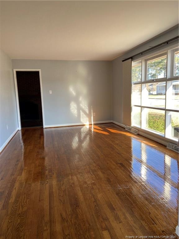 700 W 20th St W, Lumberton, NC 28358 - spare room featuring baseboards and hardwood / wood-style floors