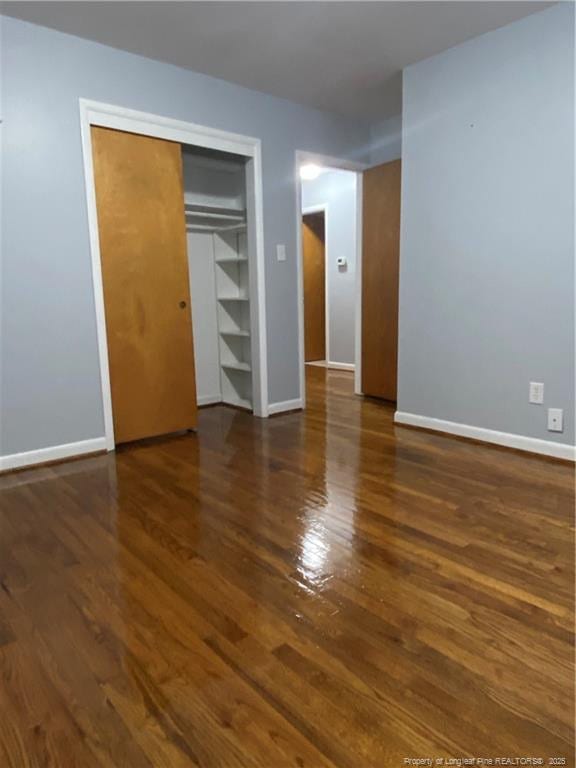 700 W 20th St W, Lumberton, NC 28358 - unfurnished bedroom with a closet, baseboards, and wood finished floors