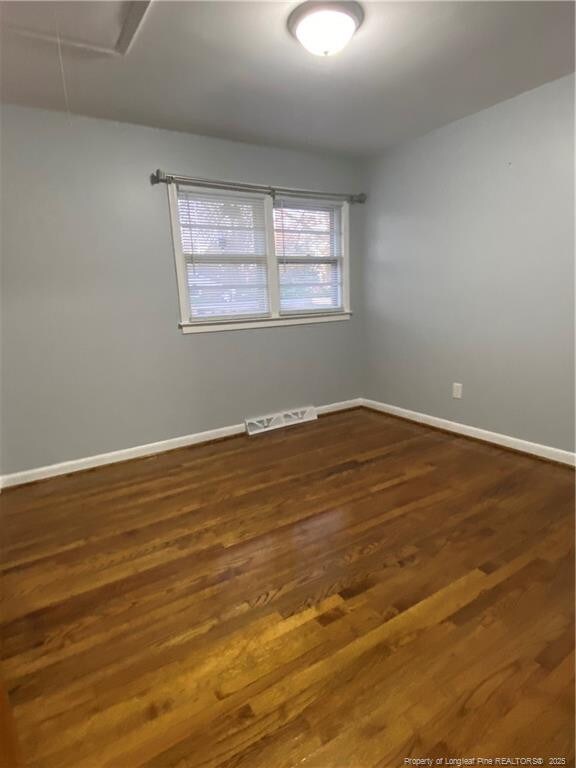 700 W 20th St W, Lumberton, NC 28358 - unfurnished room with visible vents, baseboards, and wood finished floors