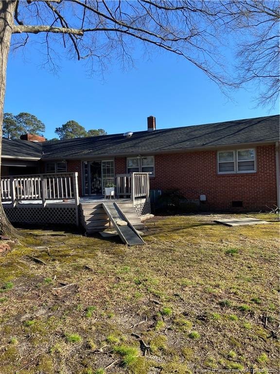 700 W 20th St W, Lumberton, NC 28358 - back of property with crawl space, a wooden deck, brick siding, and a chimney