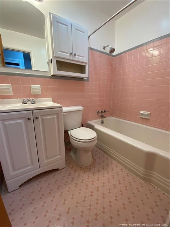 700 W 20th St W, Lumberton, NC 28358 - bathroom with vanity, tub / shower combination, tile walls, toilet, and tile patterned floors