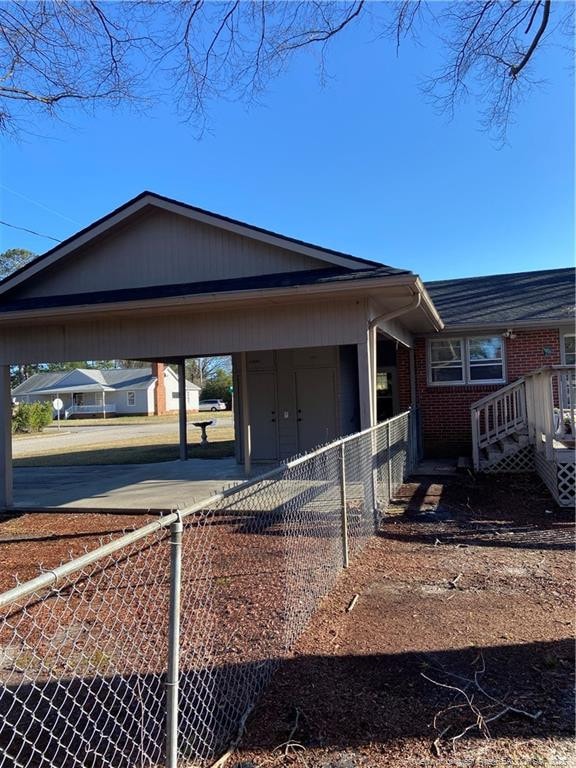 700 W 20th St W, Lumberton, NC 28358 - view of side of property with brick siding and fence