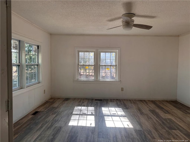 unfurnished room with crown molding, dark wood-type flooring, and a textured ceiling