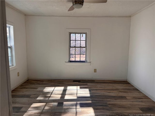 empty room featuring crown molding, ceiling fan, dark hardwood / wood-style flooring, and a textured ceiling