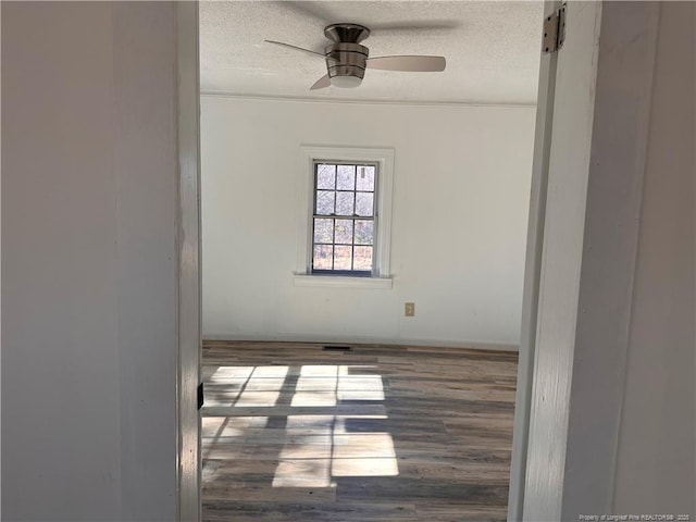 unfurnished room with a textured ceiling, ceiling fan, and hardwood / wood-style flooring