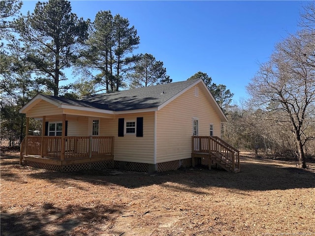 rear view of property featuring a porch