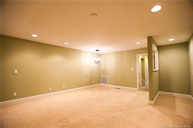 unfurnished room featuring light carpet