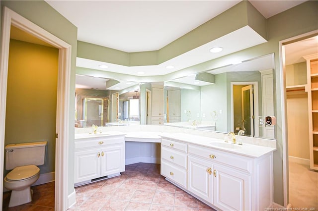 bathroom featuring tile patterned flooring, vanity, and toilet