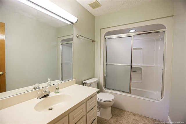 full bathroom with vanity, combined bath / shower with glass door, toilet, and a textured ceiling