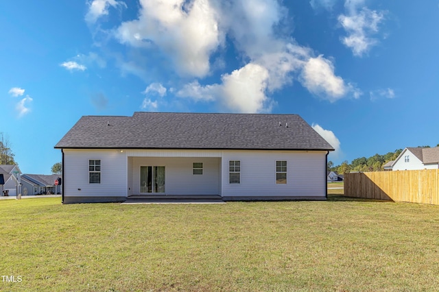 back of property featuring a lawn and a patio area