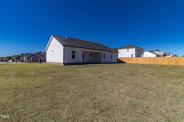 rear view of house with a yard