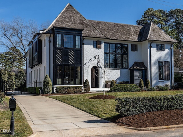 view of front of home with a front yard and brick siding