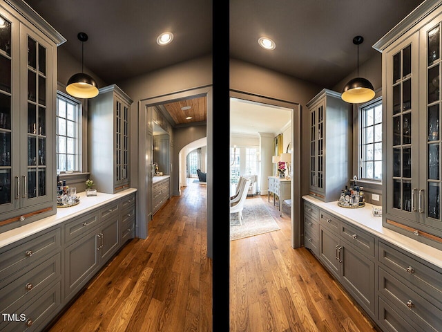 bar featuring dark wood-style floors, decorative light fixtures, and recessed lighting