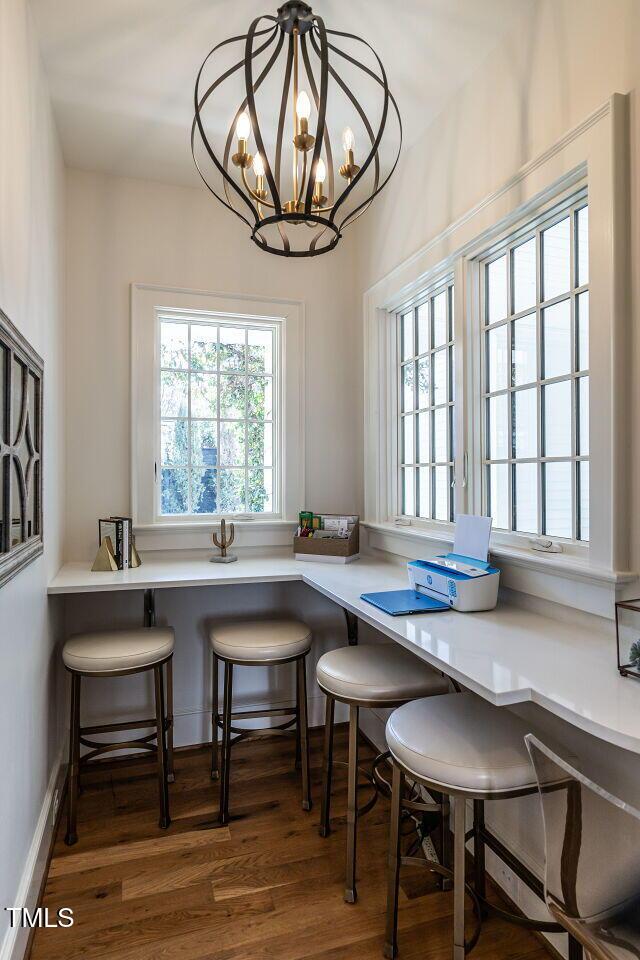 dining area featuring dark hardwood / wood-style floors and a notable chandelier