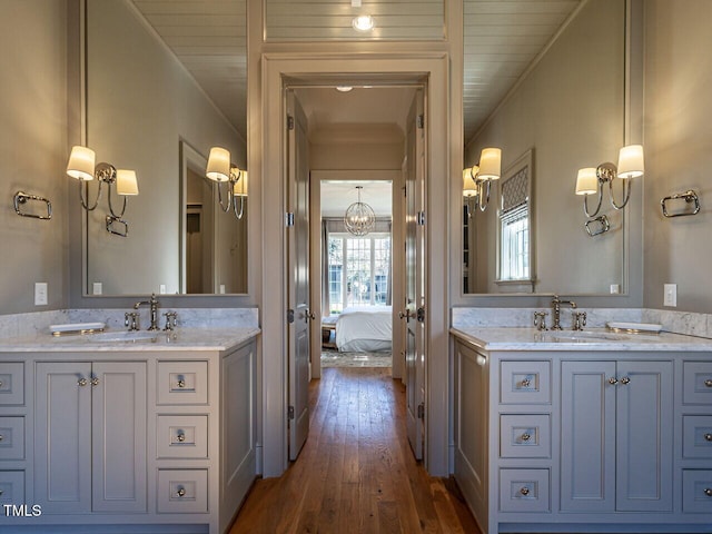 bathroom with vanity, ornamental molding, and hardwood / wood-style floors