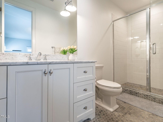 bathroom with vanity, an enclosed shower, and toilet