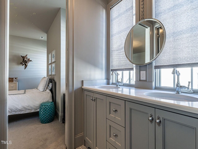 ensuite bathroom featuring a sink, ensuite bathroom, and double vanity