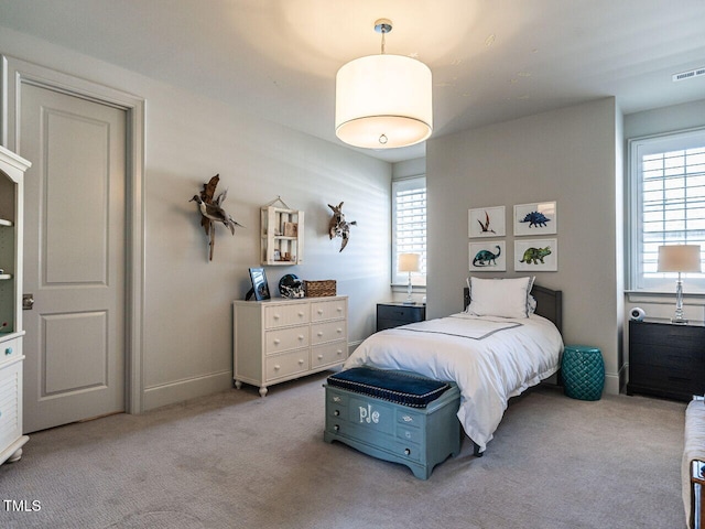 bedroom featuring light carpet